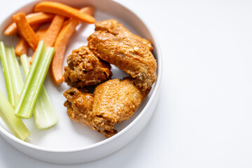 Chicken Wing Dinner with Carrots and Celery Side on Solid White Background