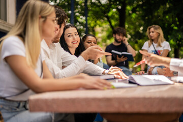 Large group of students gathered at table discussing and preparing school project, collaboration teamwork concept