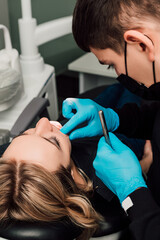 Patient at dentist's appointment. Treatment of caries and follow-up examination