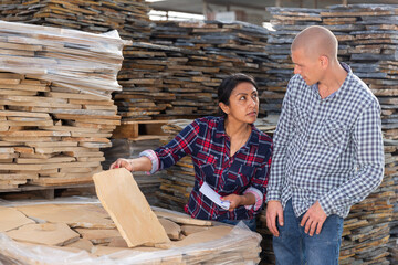 Manager and worker of the construction store keep records of natural stone tiles
