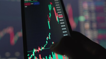 Businessman experiments with technology, using smartphone to analyze graphs charts to get real-time information about state market and movements stocks, securities, exchange rates and cryptocurrencies - Powered by Adobe