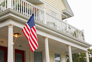 vibrant US flag waves against a clear sky, evoking American pride on a sunny day. Symbolizes patriotism, unity, and national celebration