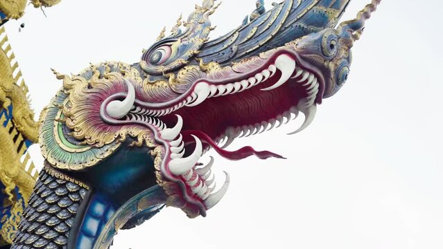 Dragon head at the entrance to WAT RONG SUEA TEN, THE BLUE TEMPLE IN CHIANG RAI, Thailand