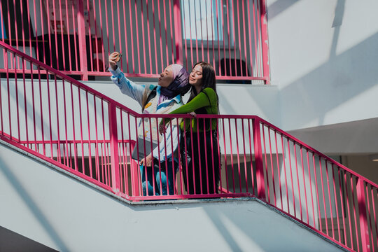 Students, one wearing a hijab, engage in a conversation in the modern school hallway, reflecting their readiness for new educational challenges and exemplifying dialogue, collaboration, and cultural