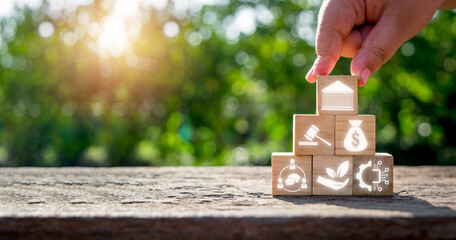 Pestel concept, Man hand holding wooden block with pestel icon on virtual screen.