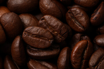 Aromatic roasted coffee beans as background, closeup