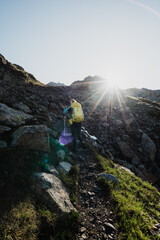 hiker in the mountains with sunlight