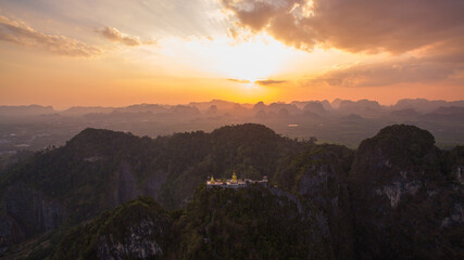 .The golden buddha on the top of high mountain. .It is more interesting temple complexes in Krabi Thailand, .as the monks live and worship within a maze of natural caves in an overgrown jungle 