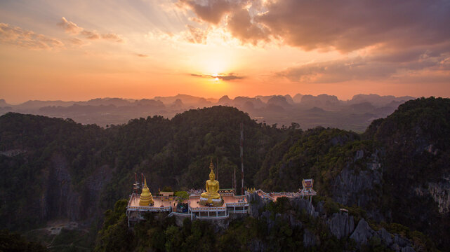 .The golden buddha on the top of high mountain. .It is more interesting temple complexes in Krabi Thailand, .as the monks live and worship within a maze of natural caves in an overgrown