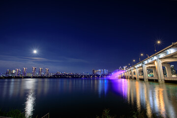 Fototapeta na wymiar moonlit river, cityscape in night, seoul, hanriver, fountain show, banpo bridge