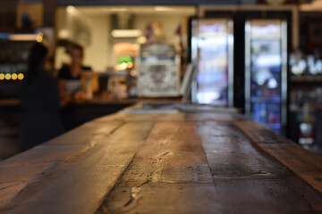 Rustic wooden table at a diner with selective focus and defocused interior