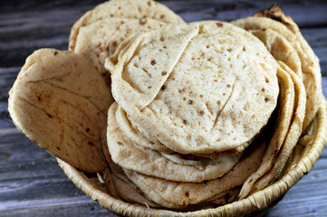 Traditional Egyptian flat bread with wheat bran and flour, regular Aish Baladi or Egypt bread baked in extremely hot ovens, it is the result of a mixture of wheat flour, yeast, salt and water - obrazy, fototapety, plakaty