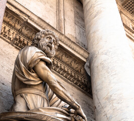 dramatic scupture in front of a detailed building