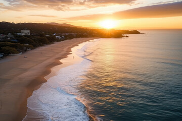 Fototapeta premium Serene Sunset Beach: A Breathtaking Aerial View of Golden Hour Glow, Vibrant Skies, and Glistening Waves, Embracing Tranquility and Coastal Beauty