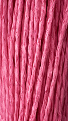 close-up abstract of bright pink paper yarn, vibrant color background texture in full frame, wallpaper design in vertical orientation