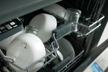 women hand closing dishwasher door .