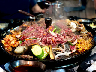raw beef slice and vegetables on hot grill - bbq, kbbq, korean bbq