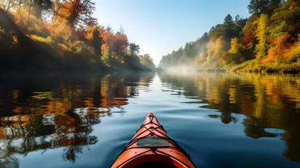 Fotobehang kayak sailing down a river on a sunny autumn day against yellow foliage trees and fog reflected in the water. Exploration of wild pristine nature and wanderlust concept. AI Generative © Lucky Ai