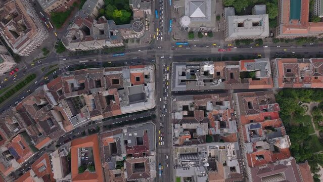 Birds eye shot of traffic in streets in metropolis. Wide multilane thoroughfares and intersections in urban borough. Budapest, Hungary