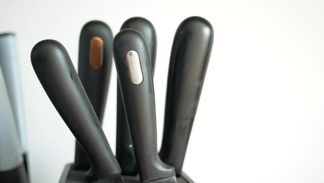 Set of kitchen knives in a box .