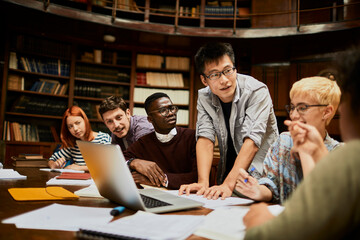 Young and diverse group of students studying in a university library