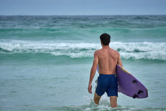 Young Man Enjoying Surfing Vacation by the Sea