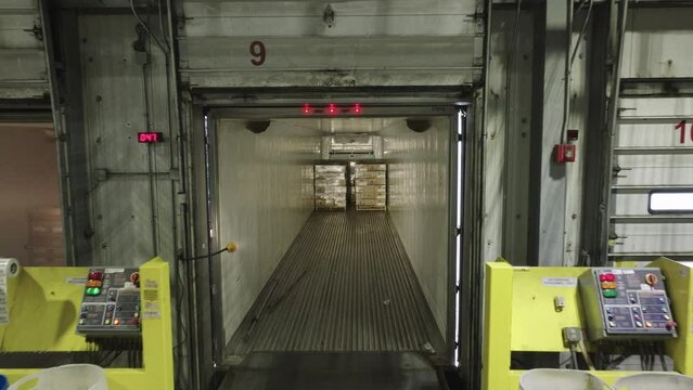 Aerial Drone Flying Inside Semi-Truck Trailer Parked at Warehouse Loading Dock