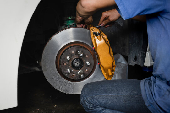 Car brake fluid bleeding service in garage service shop.