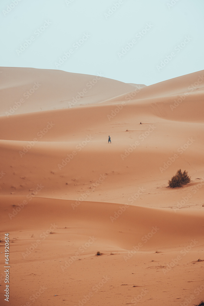 Wall mural Incidental local berber man wandering through Sahara Desert Merzouga, Morocco