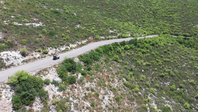 Drone Shot of Four Wheeler ATV Vehicle Moving on Road in Countryside of Zakynthos Island, Greece