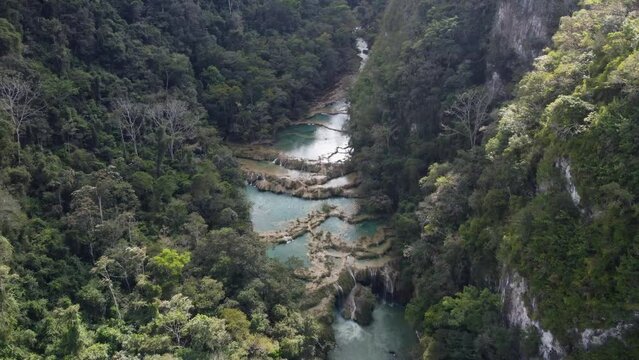 Flyover of Semuc Champey karst waterfall nature in rural Guatemala