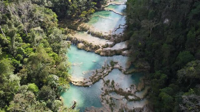 Tourists swim in river gour pools of Semuc Champey valley, Guatemala