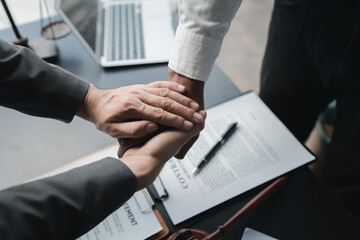 Two lawyers shake hands in a brainstorming meeting. Lawyers search for legal information together to plan how to represent clients in cases, applying the law fairly and honestly. Lawyer concept.