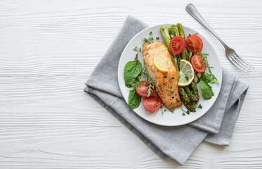 Baked Delicious salmon, green asparagus on  plate
