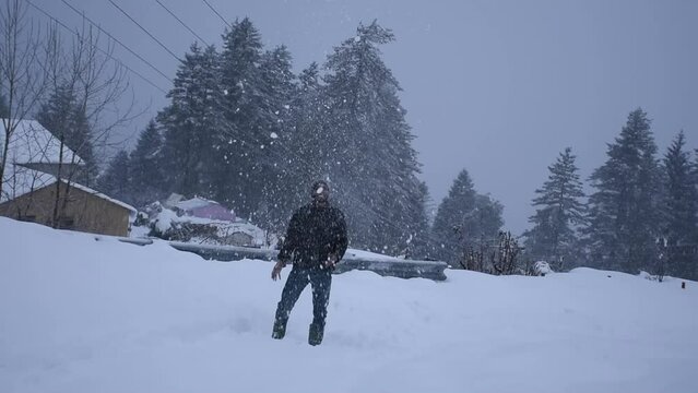  Men throwing snow in the air in winter holidays, Auli, Uttarakhand, india.
