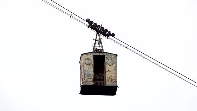 Dizzy gondola for passenger transport stands in the air because of too much wind