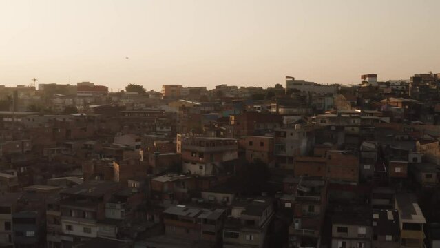 Ascending drone shot of Favela Houses in Inferninho district of Sao Paulo at sunset