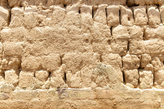 wall made of mud bricks as background and texture horizontal