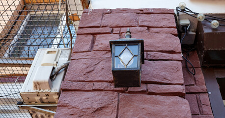 Old street lamp light on the wall. Beautiful vintage lamp on the facade