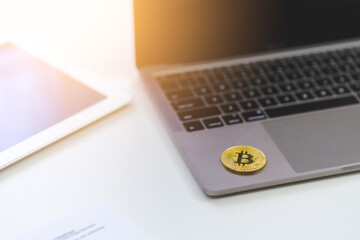 Gold Bitcoin Crypto investment and trade concept. Bitcoin Cryptocurrency logo symbol on computer laptop and tablet on white desk with copy space for texting. Virtual Crypto coin as Bitcoin is future. - 641953219