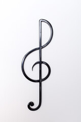 black metal treble clef on a light background. isolate
