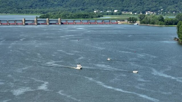 Boats on Mississippi River. Long aerial zoom shot on sunny summer day in USA.