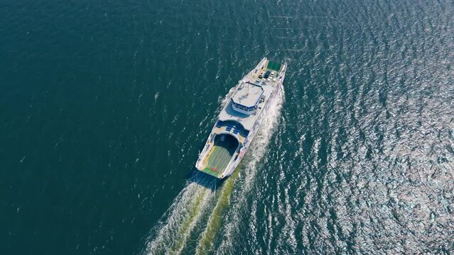Drone shot of vehicle ferry boat transporting cars across sea gulf, aerial view