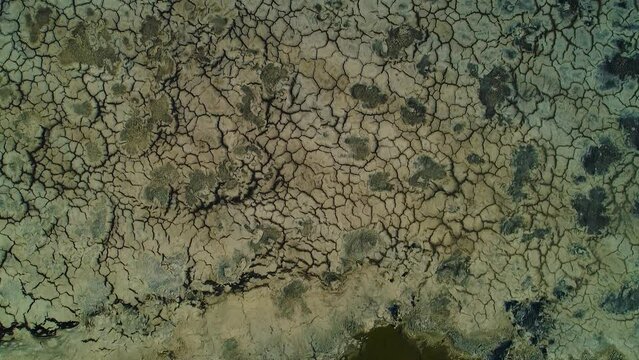 Drone top down view of cracked mud bank asphalt lake in willemstad curacao