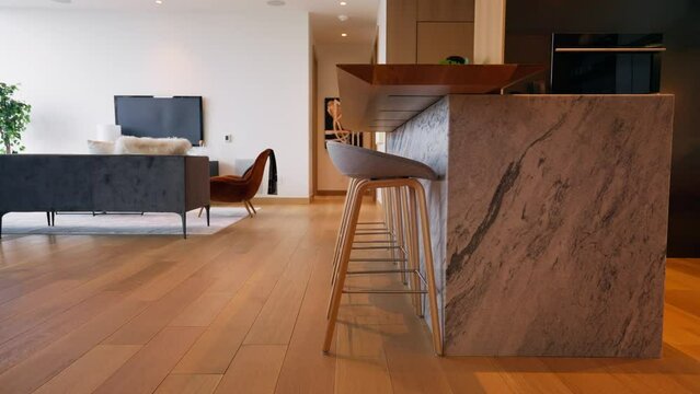 Panning shot of modern kitchen bar with marble countertop