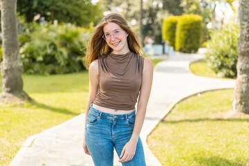 Young French girl with glasses at outdoors . Portrait