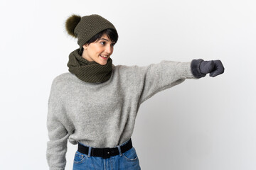 Young girl with winter hat giving a thumbs up gesture