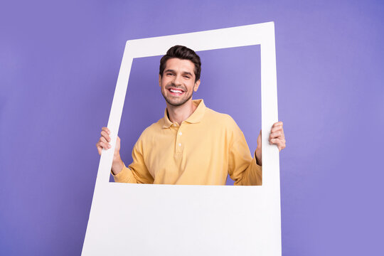 Portrait of positive friendly person have good mood arms hold paper album card isolated on purple color background
