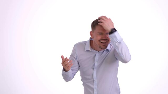 Young man narcissistically examines appearance. Adult male with brown hair walks haughtily with top button of shirt unbuttoned in studio