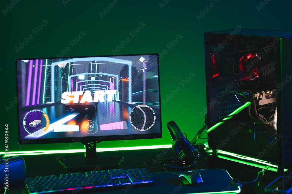 Poster composite of computer, keyboard with video game accessories with copy space on neon background